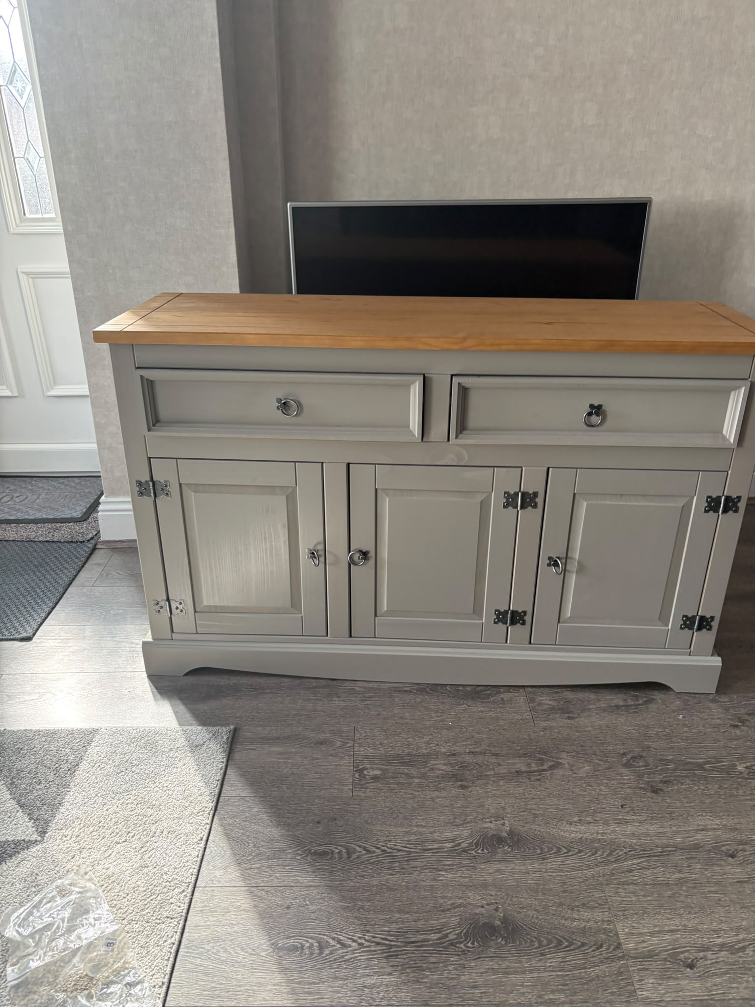 Grey three-door wooden cabinet with a natural timber top